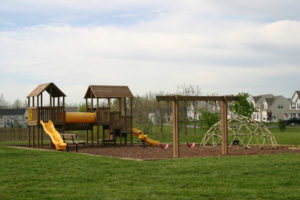 Slides, a jungle gym, and a swingset at a neighborhood playground in Charles Town, WV.