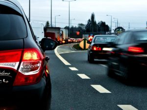 Two lanes of cars on a highway during a morning commute.