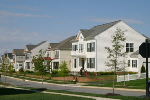 A street lined with white two-story houses in Charles Town, WV.