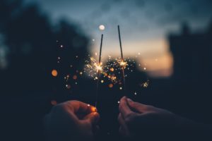 Two people holding sparklers.