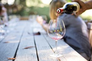 A man pouring a glass of wine.