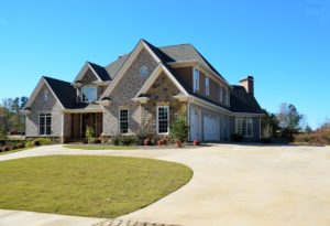 A luxury two-story brick home with a huge driveway. 