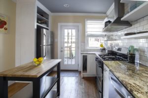 A clean and bright kitchen with a granite countertop.