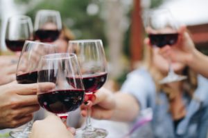 A group of friends cheersing wine glasses.