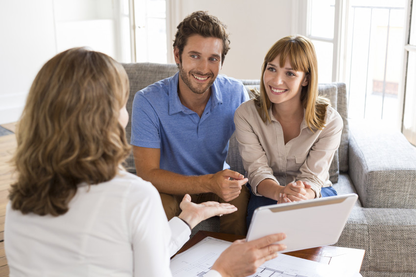 Saleswoman presenting a new project property on digital tablet.