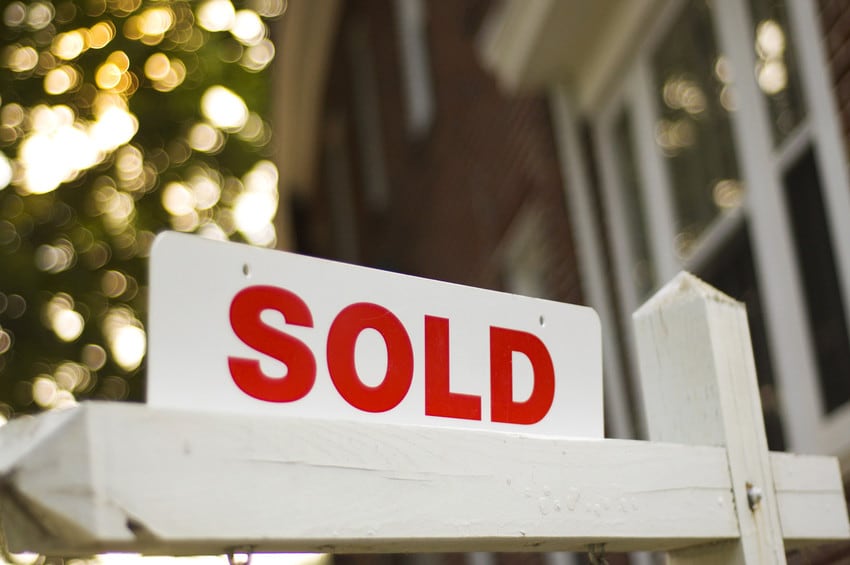 A home with a SOLD sign out front.