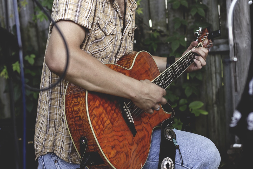 A person playing guitar on stage.