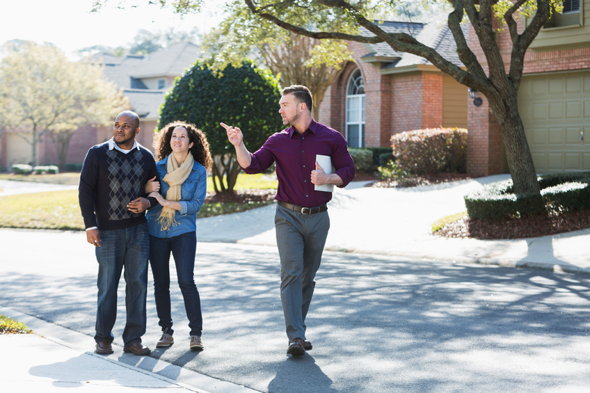 People touring homes with an agent.