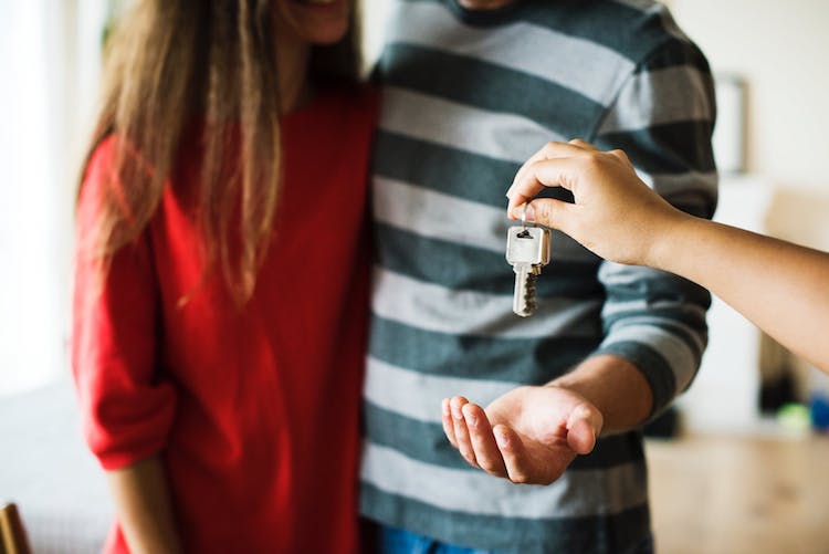 People being handed the keys to a home. 