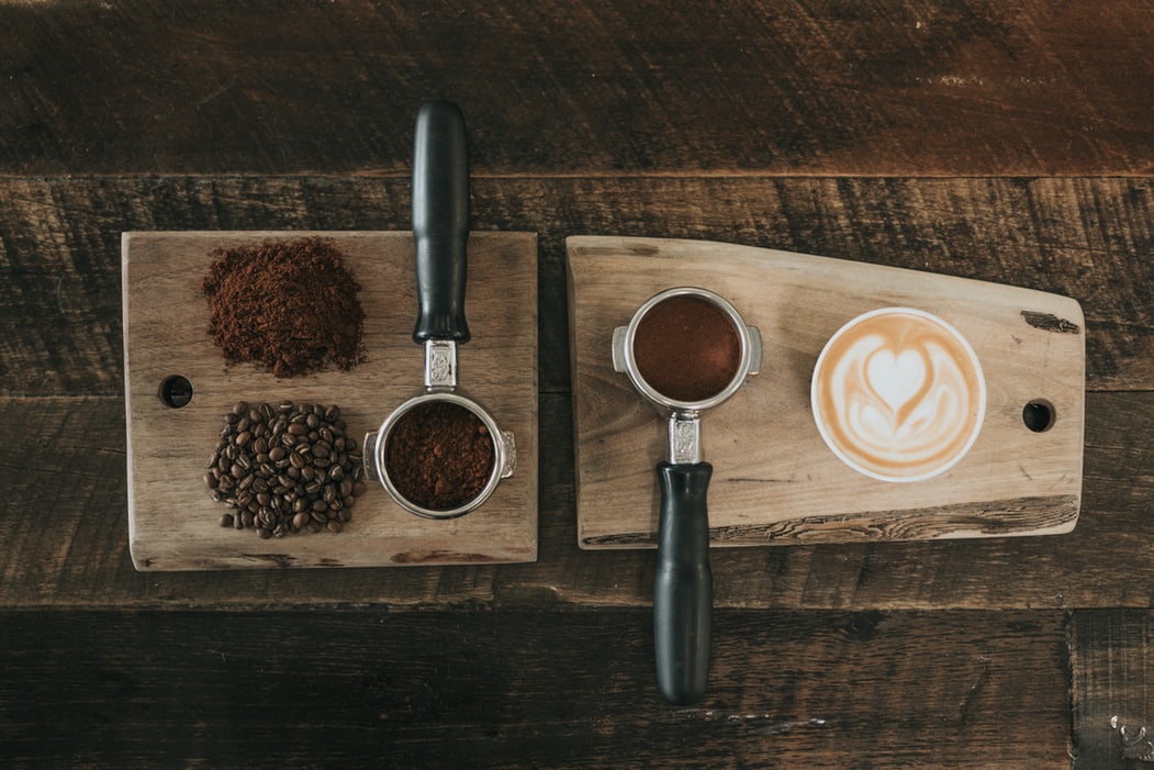 Coffee grounds, beans, and a latte.