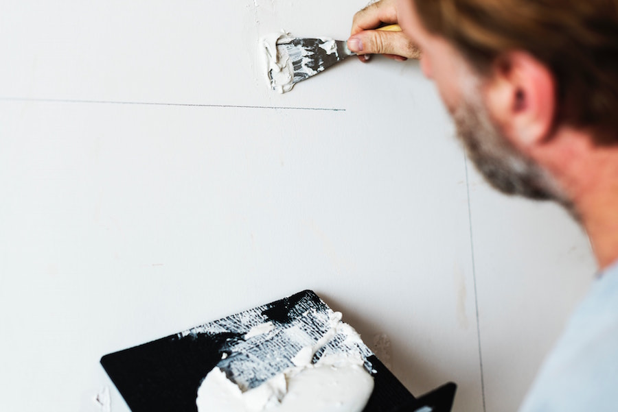 Man making repairs to a wall