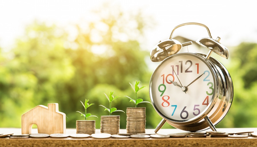 Clock with money and house figure