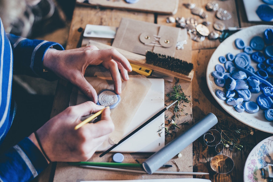 Woman making jewelry for the Charles Town Christmas Marketplace