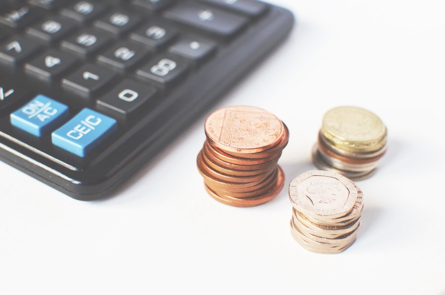 Calculator and pile of coins