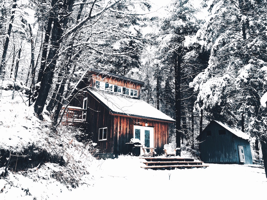 Cabin covered in snow