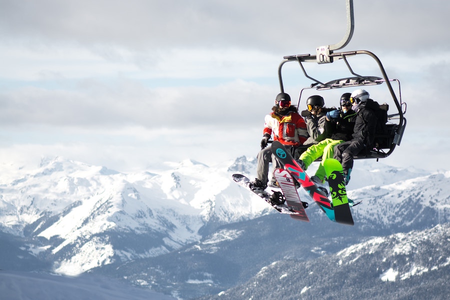 Snowboarders on a lift at winter resorts